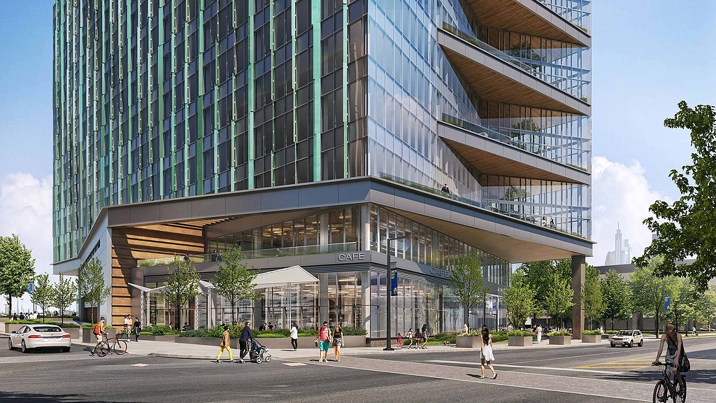 A large glass building with people walking around.